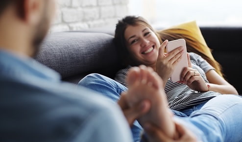 A Man Giving a Woman a Foot Massage at Home