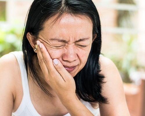 A woman with Ear Pain from TMJ